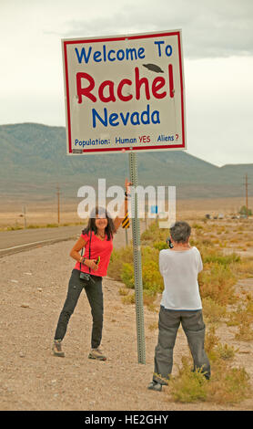 Two tourists photograph the humorous welcome sign at Rachel, Nevada Stock Photo