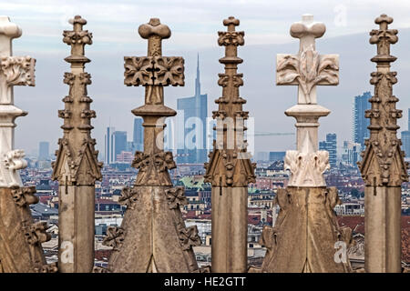 View of Milan's financial district in background and statues of Duomo of Milan in front. Lombardy, Italy. Stock Photo