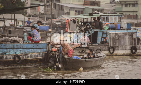 Floating market traders on the Mekong river, Vietnam Stock Photo
