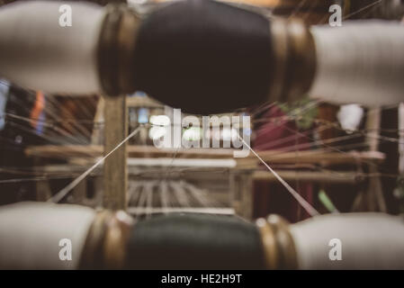 Cotton bobbins & thread on a classic wooden loom in Vietnam Stock Photo