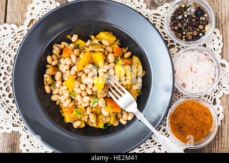 White beans stewed with meat and vegetables Stock Photo