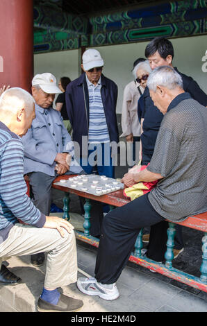 Local Chinese playing xiangqi or Chinese chess at the Temple of Heaven, Altar of Heaven Beijing, China. Stock Photo