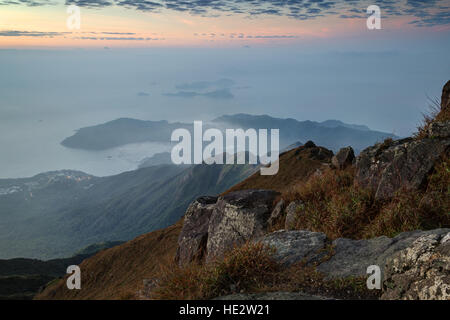 View of the coastline and hills on the Lantau Island from above, viewed from the Lantau Peak on Lantau Island in Hong Kong. Stock Photo