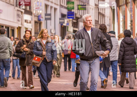 AMSTERDAM, NETHERLANDS - People stroll on Kalverstraat, in downtown Amsterdam's popular shopping street. Stock Photo