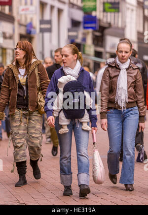 AMSTERDAM, NETHERLANDS - People stroll on Kalverstraat, in downtown Amsterdam's popular shopping street. Stock Photo
