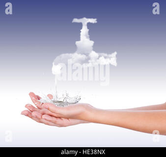 From a tap made of white clouds, pouring water on the palms splashing in all directions, in front of a blue background Stock Photo