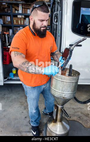 Miami Florida,Hialeah,gas station,petrol,Hispanic adult,adults,man men male,repairing pump handle,FL161125052 Stock Photo