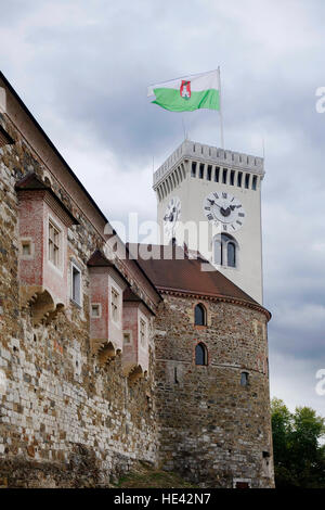 View on the part of west wall of Ljubljana Castle with tower and city flag. Stock Photo