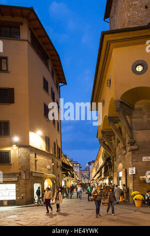 FLORENCE, ITALY - NOVEMBER 3, 2016: people near shops on Ponte Vecchio (Old Bridge) in Florence in evening. The Ponte Vecchio is medieval stone bridge Stock Photo