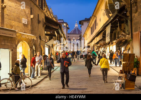 FLORENCE, ITALY - NOVEMBER 3, 2016: people in shopping area on Ponte Vecchio (Old Bridge) in Florence in evening. The Ponte Vecchio is medieval stone Stock Photo