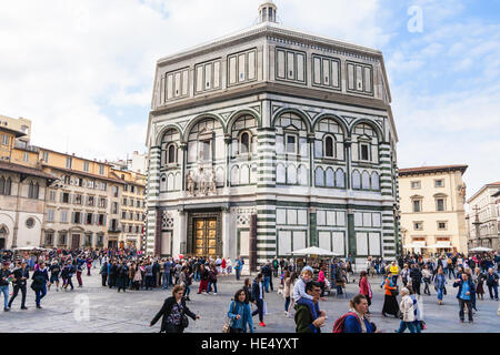 FLORENCE, ITALY - NOVEMBER 4, 2016: tourists near Florence Baptistery San Giovanni on Piazza San Giovanni. The Baptistery is one of the oldest buildin Stock Photo