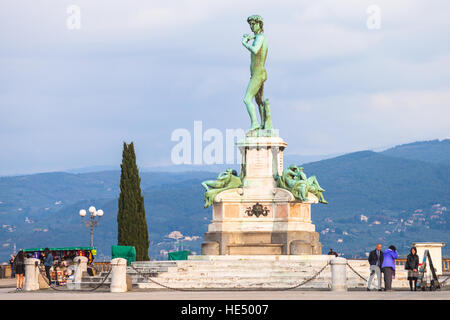 FLORENCE, ITALY - NOVEMBER 4, 2016: tourists near Bronze statue of David facing Florence city at center of Piazzale Michelangelo. This square was desi Stock Photo