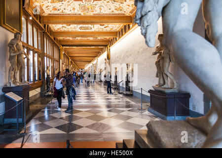 FLORENCE, ITALY - NOVEMBER 5, 2016: tourists in hallway of Uffizi Gallery. The Uffizi is one of the oldest museums in Europe, its origin refers to 156 Stock Photo