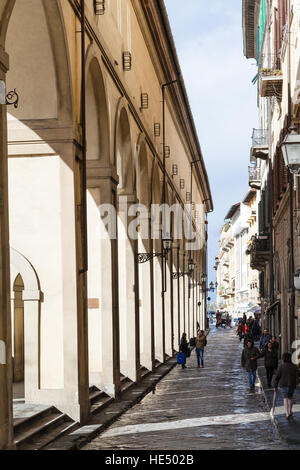 FLORENCE, ITALY - NOVEMBER 6, 2016: tourists walk near Vasari Corridor in autumn. The Vasari Corridor connects Palazzo Vecchio with Palazzo Pitti, it Stock Photo