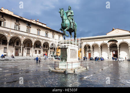 FLORENCE, ITALY - NOVEMBER 6, 2016: tourists and Equestrian Monument of Ferdinando I on Piazza della Santissima Annunziata. The Piazza is named after Stock Photo