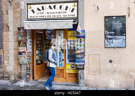 FLORENCE, ITALY - NOVEMBER 6, 2016: tourist near Tabacchi kiosk. Tabacchi (tobacco shop) is very important place for tourists, there are local bus tic Stock Photo