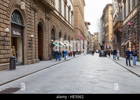 FLORENCE, ITALY - NOVEMBER 7, 2016: tourists on street via de Tornabuoni in Florence city. It is medieval street at the center of city, with houses of Stock Photo
