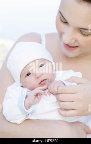Young mother, 22 years, with daughter, six weeks old, outdoors Stock Photo