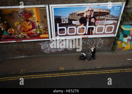 Shoppers with Louis Vuitton bags in Oxford Street London, pass bus with  advert for fashion outlet boohoo Stock Photo - Alamy