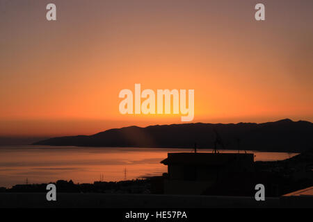 Beautiful orange sunset over the beach on the Greek island of Crete Stock Photo