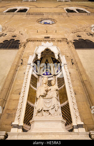 travel to Italy - facade of medieval Orsanmichele church with statue (Madonna of the Rose by sculptor Pietro di Giovanni Tedesco) in Florence city in Stock Photo