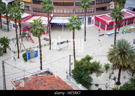 Vehicles drive through flooded streets in La Cala, Alicante province, Spain after a storm and flooding on the streets. Stock Photo