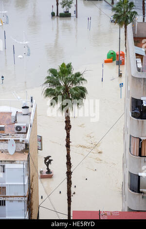 Vehicles drive through flooded streets in La Cala, Alicante province, Spain after a storm and flooding on the streets. Stock Photo