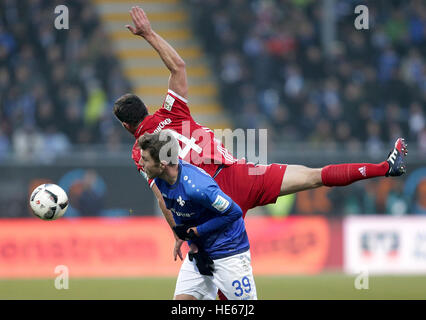 Darmstadst, Germany. 18th Dec, 2016. Darmstadt's Sven Schipplock and Munich's xabi Alonso compete for the ball during the Bundesliga soccer match between Darmstadt 98 and Bayern Munich at Jonathan Heimes stadium in Darmstadst, Germany, 18 December 2016. Photo: Hasan Bratic/dpa/Alamy Live News Stock Photo