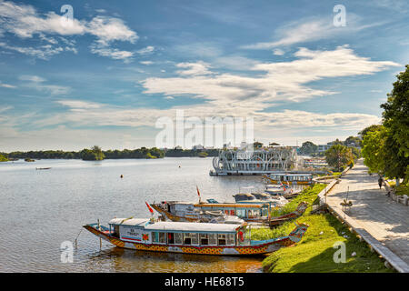 Vietnamese traditional dragon boats moored on the Perfume River. Hue, Vietnam. Stock Photo