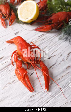 crayfish boiled with lemon and dill on a table close up. vertical Stock Photo