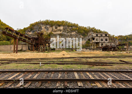 Old railway tracks and abandoned soviet sand washing factory in the Caucasus, Georgia. Stock Photo