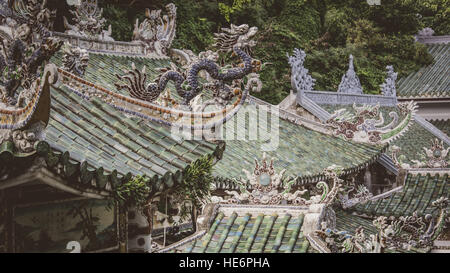 Ornate stone & marble roofs of Buddhist temples on Marble mountains, near Da Nang, Vietnam Stock Photo