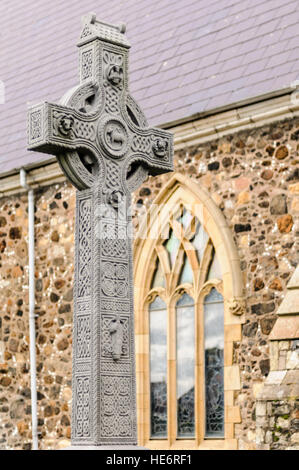 Old, intricately carved Irish Celtic Cross in the graveyard of St. Nicholas' Church, Carrickfergus, Northern Ireland. Stock Photo