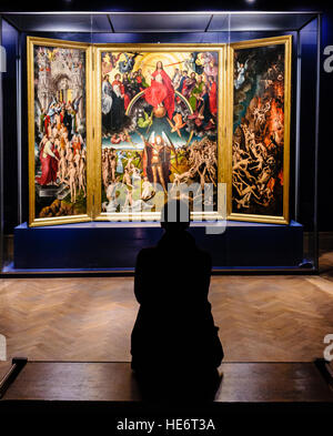 A woman sits as she admires the Last Judgment by German painter Hans Memling in the National Museum in Gdańsk in Poland Stock Photo