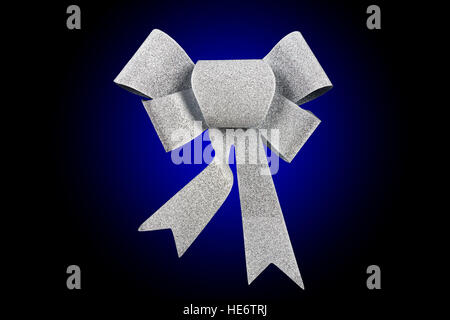 silver ribbon bow isolated on blue rounded background, studio shot Stock Photo