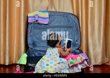Girl in Suitcase with Cellphone Stock Photo
