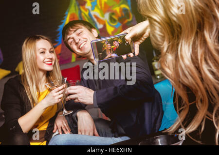 Happy couple taking photo mobile club Stock Photo