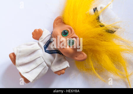 troll doll with yellow hair in uniform Stock Photo