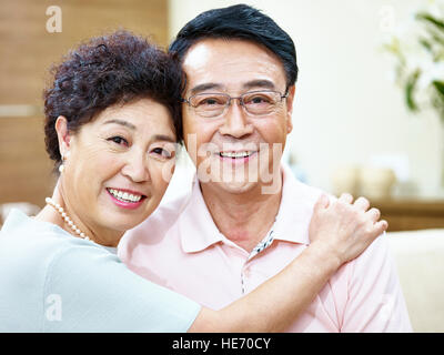 portrait of a happy senior asian couple looking at camera smiling. Stock Photo