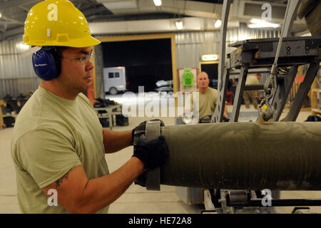 Senior Airman Kenneth Bird, a conventional munitions maintainer assigned to the 451st Expeditionary Maintenance Squadron at Kandahar Airfield, Afghanistan, guides a bomb being transferred to the assembly rack to be built June 9, 2012. Personnel are deployed from McEntire Joint National Guard Base, S.C., in support of Operation Enduring Freedom. Swamp Fox F-16s, pilots, and support personnel began their air expeditionary force deployment early April to take over flying missions for the air tasking order and provide close air support for troops on the ground in Afghanistan. Stock Photo