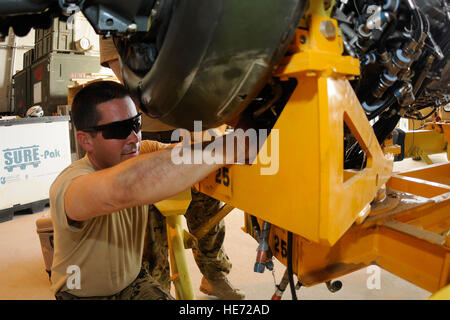 U.S. Army Sgt. Michael Johnson, an engine mechanic, works on the engine for a CH-47 Chinook at Kandahar Airfield, Afghanistan, July 3, 2012. Johnson, a native of Riverside, Calif., is currently deployed to Afghanistan with Delta Company, 3rd Battalion, 25th Aviation Regiment out of Wheeler Army Airfield, Hawaii. Stock Photo