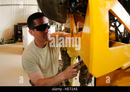 U.S. Army Sgt. Michael Johnson, an engine mechanic, works on the engine for a CH-47 Chinook at Kandahar Airfield, Afghanistan, July 3, 2012. Johnson, a native of Riverside, Calif., is currently deployed to Afghanistan with Delta Company, 3rd Battalion, 25th Aviation Regiment out of Wheeler Army Airfield, Hawaii. Stock Photo