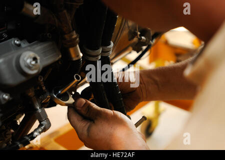 U.S. Army Sgt. Michael Johnson, an engine mechanic, works on the engine for a CH-47 Chinook at Kandahar Airfield, Afghanistan, July 3, 2012. Johnson, a native of Riverside, Calif., is currently deployed to Afghanistan with Delta Company, 3rd Battalion, 25th Aviation Regiment out of Wheeler Army Airfield, Hawaii. Stock Photo