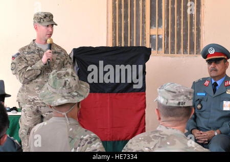 U.S. Army 1st Lt. Paul Elliott, Academy Officer-in-Charge (left) emcees graduation ceremonies for the ANP Criminal Investigations Course as Afghan National Police Brig. Gen. Nasrullah Zarefi (right) listens, at Camp Nathan Smith, Sept. 28 at Kandahar, Afghanistan. Students studied interview techniques, basic criminal investigation, forensics, improvised explosive devices, mine awareness and basic medical procedures. Stock Photo