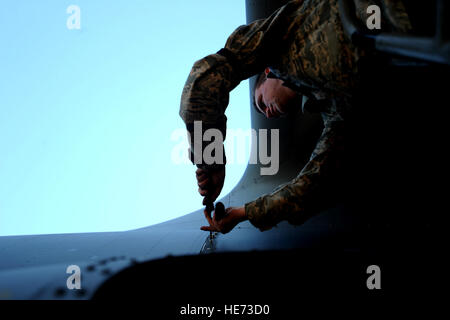 AC-130U gunship Crew Chief A1C James Marsh from the 4th Aircraft Maintenance Squadron, attaches a panel back on to the plane during routine maintenance on January 28,2011 at Hurlburt Field, Fla. The AC-130U 'Spooky' gunship is the primary weapon of Air Force Special Operations Command. Its primary missions are close air support, air interdiction and armed reconnaissance. The U model is an upgraded version of the H and is equipped with side firing, trainable 25mm, 40mm, and 105mm guns. ( Master Sgt. Jeremy T. Lock) (Released) Stock Photo