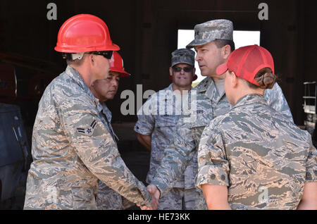 Maj. Gen. Timothy Byers, the Air Force Civil Engineer, Headquarters U.S. Air Force, thanks Airman 1st Class Adam Recob, 554th RED HORSE Squadron structures specialist, for his dedication during a tour on Northwest Field, Guam, Feb. 28, 2013. Byers and leaders from the U.S. Navy and Marine Corps toured base structures and developments to gain insight on successes and challenges within Joint Region Marianas. (U.S.  Staff Sgt. Alexandre Montes Stock Photo