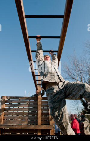 Technical Sgt. Will Thorowgood, security police with the 123rd Security Force Squadron, sways on the monkey bars at Southern High School in Louisville, Ky., on Dec. 10. Airmen of the 123rd Security Force Squadron were at the high school to use the JROTC’s obstacle course as a team building exercise in part with the Kentucky Air National Guard Wingman Day. Stock Photo