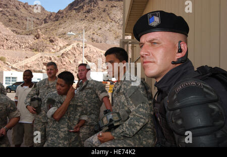 NELLIS AIR FORCE BASE, Nev. -- Nellis Airmen look on during filming of the Transformers movie on location at the Hoover Dam June 9, while waiting for their opportunity to get in front of the camera. Sixty-five Airmen from Nellis served as extras for the film, playing as Army medevac troops, Sector 7 commandos, Hoover Dam security guards and tourists. filming began at Hoover Dam June 8 and ended Saturday...  Staff Sgt. Kenny Kennemer  (released) Stock Photo