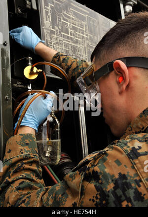 U.S. Marine Corps Cpl. Daniel Ramirez, 9th Engineer Support Battalion bulk fuel technician, takes a sample from a fuel tank during a Field Exchange Program on Kadena Air Base, Japan, Feb. 6, 2014. The 18th Logistics Readiness Squadron is the largest fuel operation in Pacific Air Forces and recently took part in a Field Exchange Program in which five Marines came to work with the 18th LRS for six months.  Naoto Anazawa) Stock Photo