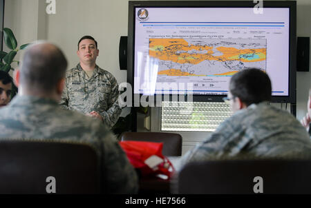 Senior Airman Zan Walker, 7th Weather Squadron battlefield weather forecaster, listens to fellow Airmen critique his briefing Sept. 17, 2015, at Grafenwohr Training Area, Germany. The instructors of the 7th WS used a variety of tools including briefing and hands-on lessons to develop 30 battlefield weather airmen during the annual Cadre Focus training exercise. The 7th WS revamped Cadre Focus to concentrate on basic field training skills and forecasting in Eastern Europe. The squadron is the only one embedded alongside Army units providing weather intelligence throughout the European and Afric Stock Photo